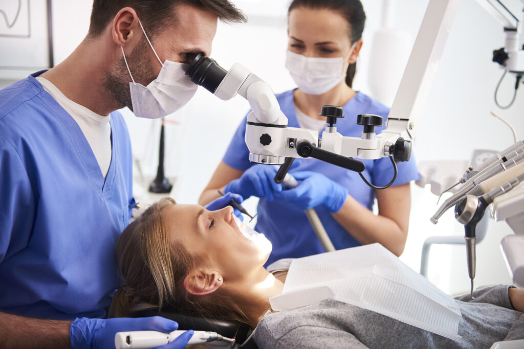 Dentist preforming a dental exam on a patient in Indianapolis