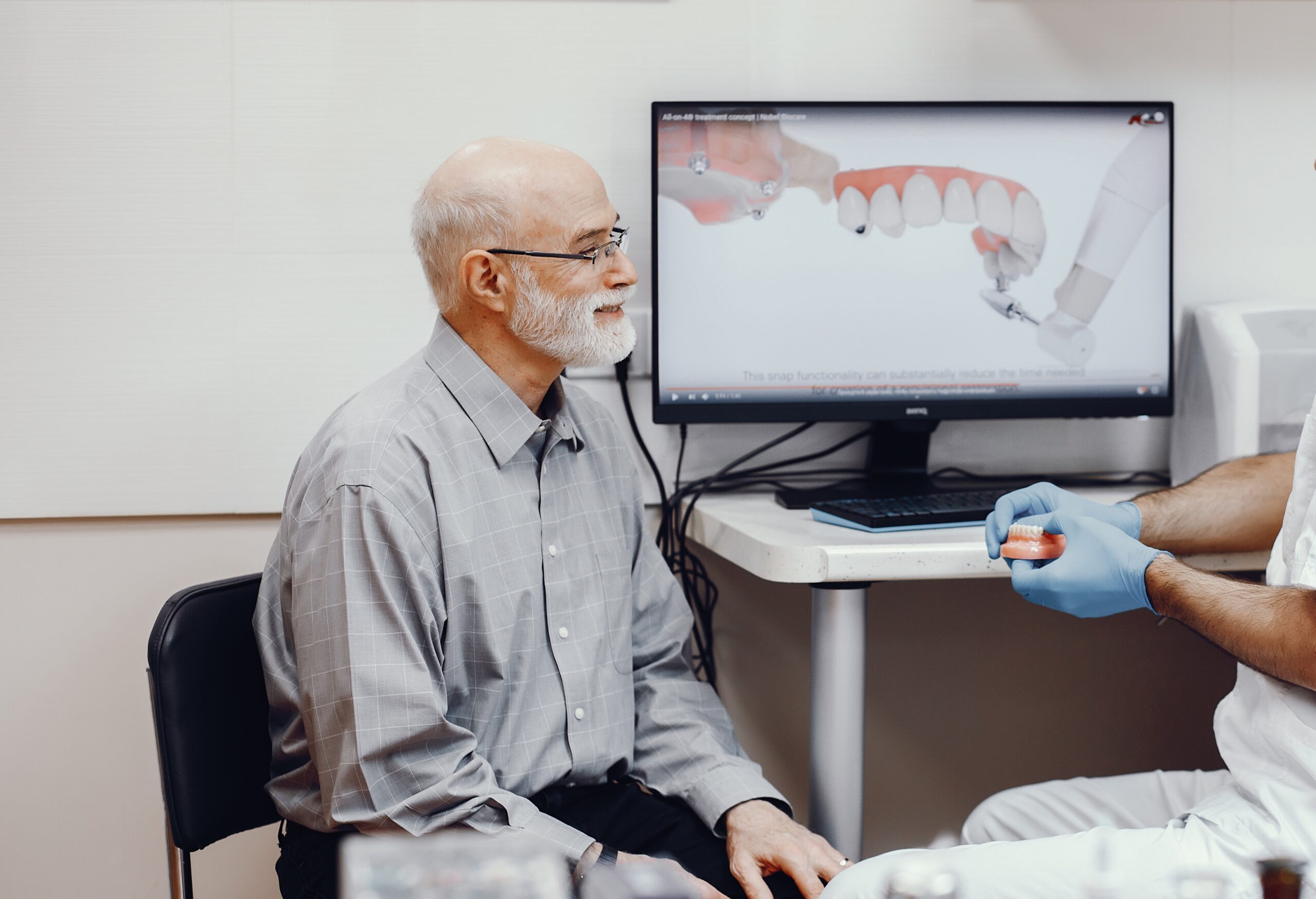 man sitting for full mouth dental implant consult
